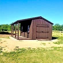10 x 20 high board and batten with double doors and a 6 foot side porch.
